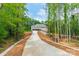 Long, paved driveway leading to a brick home with an attached two-car garage at 4028 Spindrift Cove Dr # 59 And 60, Denver, NC 28037
