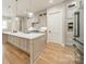 Modern kitchen features a large island, stainless steel appliances, and bright white cabinets at 4028 Spindrift Cove Dr # 59 And 60, Denver, NC 28037