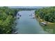 Scenic aerial view of a serene lake surrounded by lush greenery and waterfront homes at 4028 Spindrift Cove Dr # 59 And 60, Denver, NC 28037