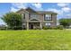 Charming two-story gray brick home with a manicured lawn and lush landscaping at 410 Alucio Ct, Matthews, NC 28104