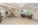Inviting foyer featuring elegant staircase, wainscoting, chandelier and a view of the front door at 410 Alucio Ct, Matthews, NC 28104