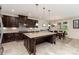 Open-concept kitchen with dark wood cabinets, stainless steel appliances, large island, and adjoining breakfast area at 410 Alucio Ct, Matthews, NC 28104