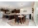 Open-concept kitchen featuring dark wood cabinets, stainless steel appliances and a breakfast nook at 410 Alucio Ct, Matthews, NC 28104
