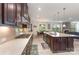 Modern kitchen with dark wood cabinets, stainless steel appliances, spacious island, and open concept design at 410 Alucio Ct, Matthews, NC 28104