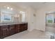 This primary bathroom features dual sinks, granite countertops, a large mirror, and a walk-in shower at 410 Alucio Ct, Matthews, NC 28104