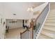 Elegant staircase with decorative wrought iron spindles and neutral carpeting at 410 Alucio Ct, Matthews, NC 28104