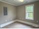 Cozy bedroom featuring carpet, window letting in natural light, and outlets along the neutral walls at 4402 Poxon Ln, Monroe, NC 28110