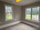 Bedroom features carpeted floors, two windows, and a neutral color palette at 4402 Poxon Ln, Monroe, NC 28110