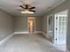 Neutral bedroom featuring carpet, fresh paint, a ceiling fan, and two closets at 4402 Poxon Ln, Monroe, NC 28110