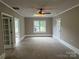 Spacious bonus room featuring carpeted floor, ceiling fan, and natural light at 4402 Poxon Ln, Monroe, NC 28110