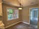 Cozy dining area boasts natural light and modern lighting fixture at 4402 Poxon Ln, Monroe, NC 28110