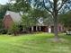 Traditional brick home with a well-manicured lawn and inviting front porch at 4402 Poxon Ln, Monroe, NC 28110