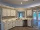 Cozy kitchen showcasing bright cabinetry, neutral marble counters and stainless appliances at 4402 Poxon Ln, Monroe, NC 28110