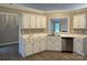 Well-lit kitchen featuring white cabinets, marble countertops, and stainless steel appliances at 4402 Poxon Ln, Monroe, NC 28110