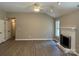 Living room with a white brick fireplace, vaulted ceiling, and neutral paint at 4402 Poxon Ln, Monroe, NC 28110