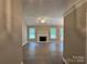 Spacious living room featuring a white fireplace, neutral walls, and wood-look floors at 4402 Poxon Ln, Monroe, NC 28110