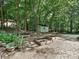 Backyard area with storage shed, raised garden beds and gravel at 443 Hillcrest Dr, Harrisburg, NC 28075