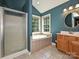 Bright bathroom featuring a soaking tub, a separate shower, and a single vanity at 443 Hillcrest Dr, Harrisburg, NC 28075