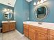 Elegant bathroom with double vanities, stylish mirrors, and tiled flooring at 443 Hillcrest Dr, Harrisburg, NC 28075
