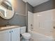Neutral bathroom with a tub-shower combo, granite vanity, and contemporary finishes at 443 Hillcrest Dr, Harrisburg, NC 28075
