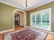 Dining room showcasing hardwood floors, large window, and an archway leading to other living spaces at 443 Hillcrest Dr, Harrisburg, NC 28075