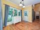 The dining area has wood floors, a window view, and a classic sideboard with lighting at 443 Hillcrest Dr, Harrisburg, NC 28075