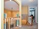 A hallway view reveals a staircase, a living area with a fireplace, and natural light at 443 Hillcrest Dr, Harrisburg, NC 28075