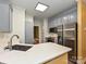 Spacious kitchen with white countertops, gray cabinets, stainless steel appliances, and ample natural light at 443 Hillcrest Dr, Harrisburg, NC 28075