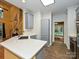 Modern kitchen featuring white countertops, gray cabinets, and stainless steel appliances with view to staircase at 443 Hillcrest Dr, Harrisburg, NC 28075