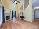 The living room features a soaring ceiling, fireplace, hardwood floors, and staircase at 443 Hillcrest Dr, Harrisburg, NC 28075