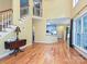 The living room features hardwood floors, fireplace, staircase, and natural light at 443 Hillcrest Dr, Harrisburg, NC 28075