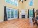 The living room features a fireplace, hardwood floors, large windows, and natural light at 443 Hillcrest Dr, Harrisburg, NC 28075