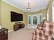 Cozy living room with bay windows, neutral carpet, and comfortable seating area at 443 Hillcrest Dr, Harrisburg, NC 28075