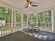 Cozy screened porch with ceiling fan and outdoor views at 443 Hillcrest Dr, Harrisburg, NC 28075