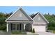 Charming home showcasing a harmonious blend of siding and stone accents, enhanced by professionally landscaped yard at 5123 Raging Creek Dr, Indian Trail, NC 28079