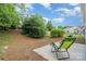 Backyard features lawn, shade trees, and patio with outdoor chairs at 5141 Grandview Dr, Fort Mill, SC 29707