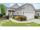 Landscaped front yard with gray siding, a brick foundation, and a well-kept lawn at 5141 Grandview Dr, Fort Mill, SC 29707