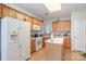 Charming kitchen with wooden cabinets, island, and modern white appliances at 5141 Grandview Dr, Fort Mill, SC 29707