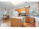 Well-lit kitchen featuring wooden cabinets, a functional island, and ample natural light at 5141 Grandview Dr, Fort Mill, SC 29707