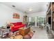 Cozy living room with a comfortable red sofa, ceiling fan, and natural light at 5141 Grandview Dr, Fort Mill, SC 29707