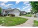 A well-maintained neighborhood street featuring manicured lawns and sidewalks under a sunny blue sky at 5141 Grandview Dr, Fort Mill, SC 29707