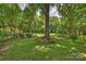 The expansive, lush backyard with mature trees and manicured landscaping at 5211 Londonderry Rd, Charlotte, NC 28210