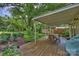Spacious backyard features a wooden deck with a covered patio and a large lawn area at 5211 Londonderry Rd, Charlotte, NC 28210