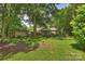 The lush lawn with stone pathways leads to additional outdoor seating at 5211 Londonderry Rd, Charlotte, NC 28210