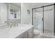 Clean bathroom with new fixtures, white marble countertop, and modern glass shower door at 5211 Londonderry Rd, Charlotte, NC 28210