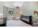 Charming Bedroom featuring a stylish crib, cozy seating, soft lighting, and cheerful décor at 5211 Londonderry Rd, Charlotte, NC 28210