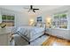 Comfortable bedroom with natural light, hardwood floors, a ceiling fan, and neutral-colored walls at 5211 Londonderry Rd, Charlotte, NC 28210