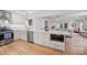 Open kitchen with white cabinets, stainless appliances, large island, and seamless connection to the living area at 5211 Londonderry Rd, Charlotte, NC 28210
