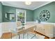 Stylish home office with a modern desk, comfortable chair, decorative clock, and natural light from a large window at 5211 Londonderry Rd, Charlotte, NC 28210