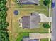 Aerial view showcasing a home with a spacious yard, trampoline, and surrounding neighborhood at 5797 Mcclintock Dr, Denver, NC 28037